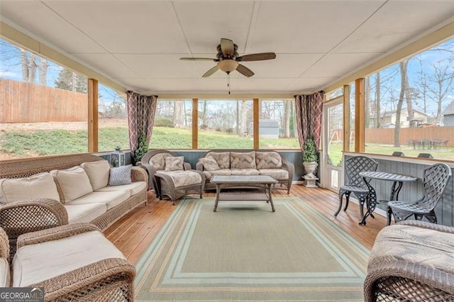 sunroom / solarium featuring ceiling fan and a wealth of natural light