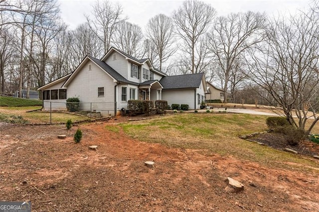 view of side of home featuring a garage, a sunroom, and a lawn