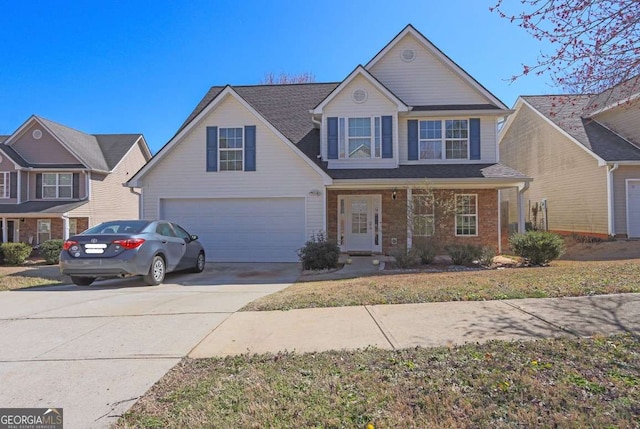 traditional home featuring driveway, a garage, and brick siding