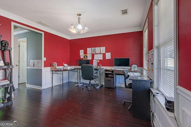 office with wainscoting, visible vents, crown molding, and wood finished floors