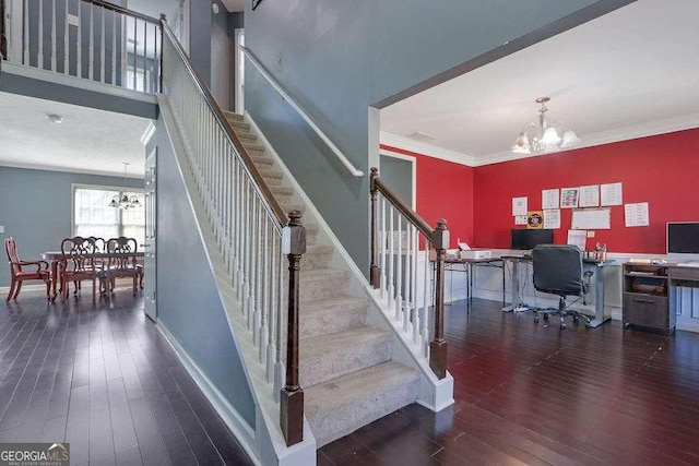 staircase with baseboards, a chandelier, wood finished floors, and ornamental molding