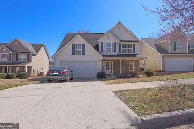 traditional home with driveway, brick siding, and an attached garage