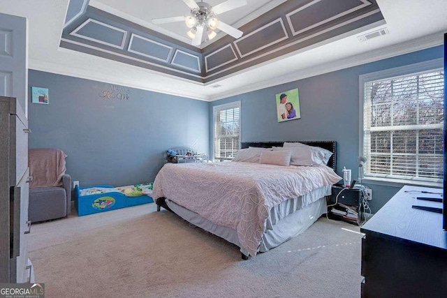 carpeted bedroom featuring visible vents, coffered ceiling, a ceiling fan, and ornamental molding