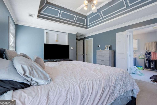 carpeted bedroom featuring ornamental molding, coffered ceiling, and visible vents