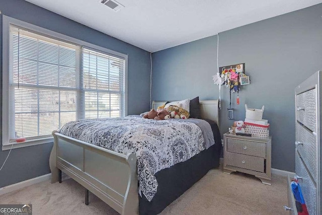 bedroom with carpet floors, visible vents, and baseboards