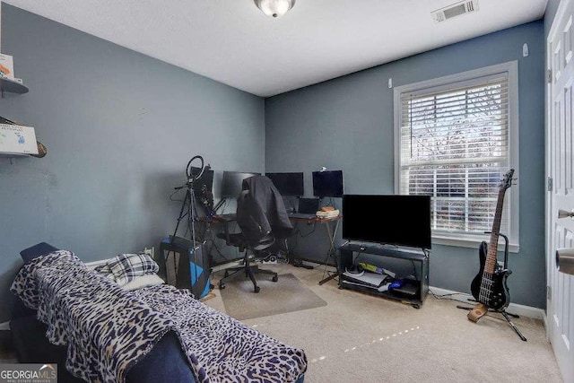 carpeted office with visible vents and baseboards