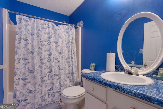 bathroom featuring toilet, a textured ceiling, a shower with shower curtain, and vanity