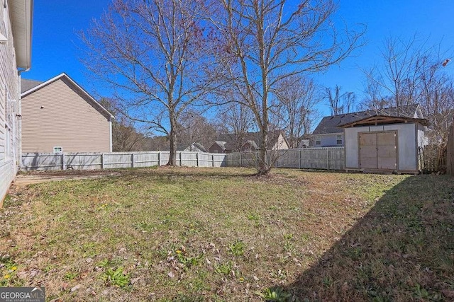 view of yard featuring a fenced backyard, an outdoor structure, and a storage shed