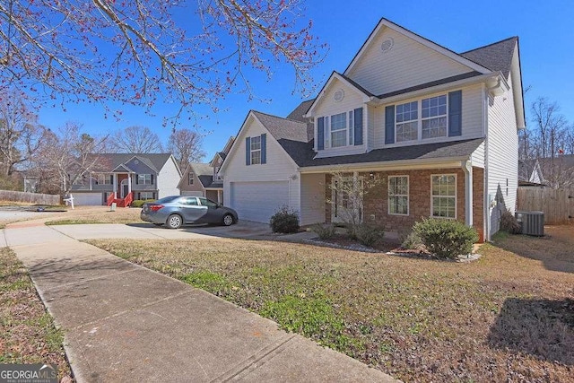 traditional-style home with a garage, central AC, brick siding, fence, and driveway