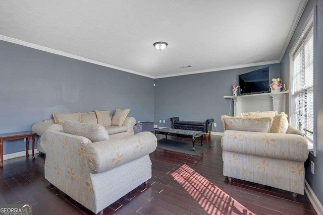 living area with visible vents, baseboards, crown molding, and wood finished floors