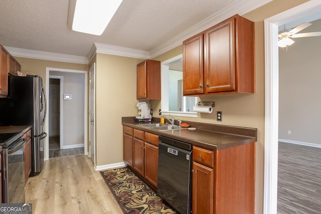 kitchen with range with electric cooktop, dishwasher, dark countertops, light wood-style flooring, and a sink