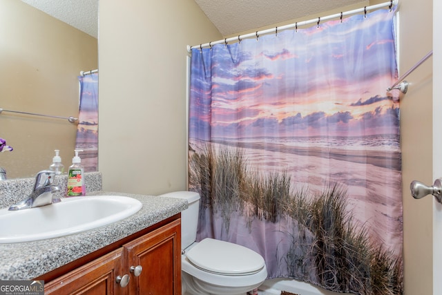 full bath with a textured ceiling, toilet, and vanity