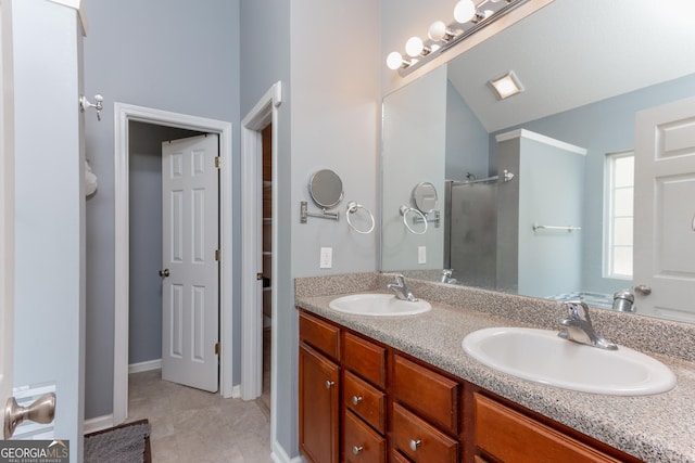 full bathroom with tile patterned floors, walk in shower, a sink, and double vanity