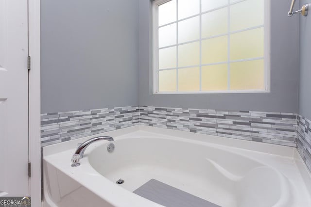 full bath featuring a garden tub and plenty of natural light