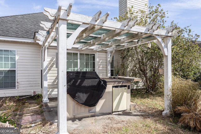 view of patio featuring a grill and a pergola