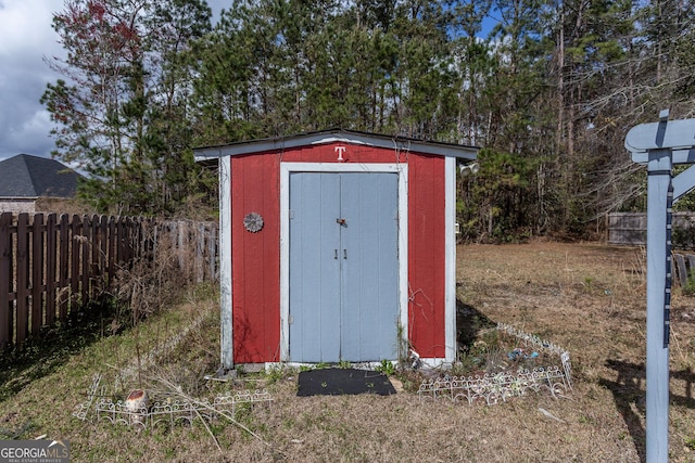 view of shed featuring fence