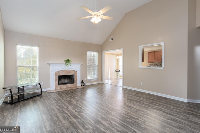 unfurnished living room featuring a fireplace, baseboards, and wood finished floors