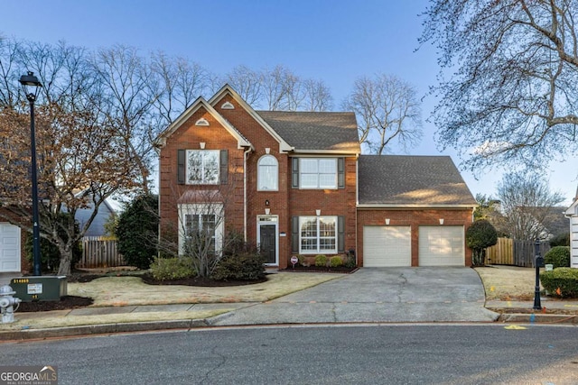 view of front of house with a garage, concrete driveway, roof with shingles, fence, and brick siding