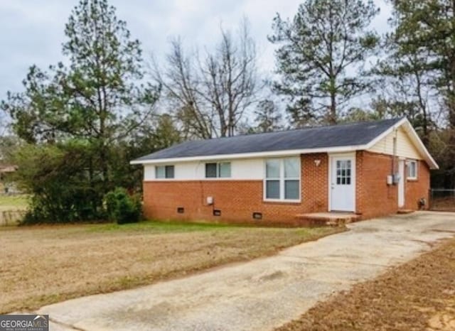 ranch-style house with crawl space, a front yard, concrete driveway, and brick siding