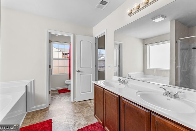 full bathroom featuring a garden tub, toilet, visible vents, and a sink