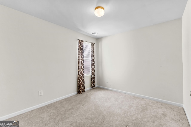 carpeted spare room with baseboards