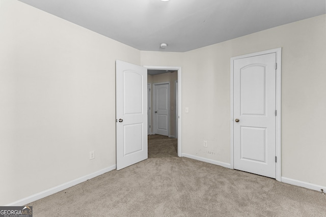 unfurnished bedroom with baseboards and carpet floors