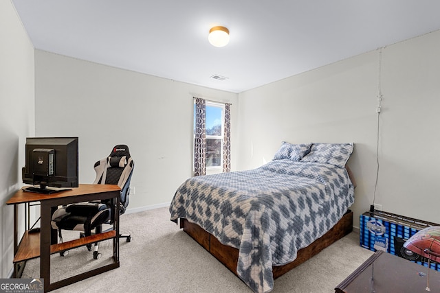 carpeted bedroom with visible vents and baseboards