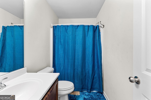 full bathroom featuring toilet, vanity, and a shower with curtain