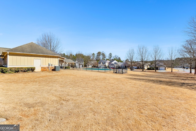 view of yard featuring cooling unit and a residential view