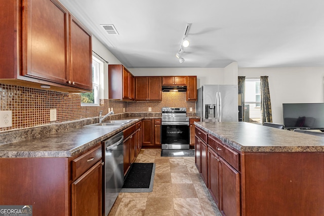 kitchen featuring a sink, stainless steel appliances, dark countertops, and ventilation hood