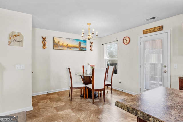 dining space featuring a notable chandelier, baseboards, and visible vents