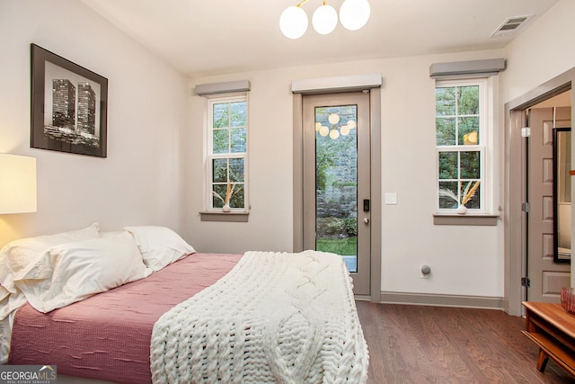 bedroom with access to outside, dark wood finished floors, visible vents, and baseboards