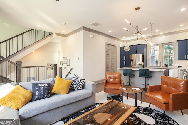 living area with recessed lighting, visible vents, baseboards, stairs, and an inviting chandelier