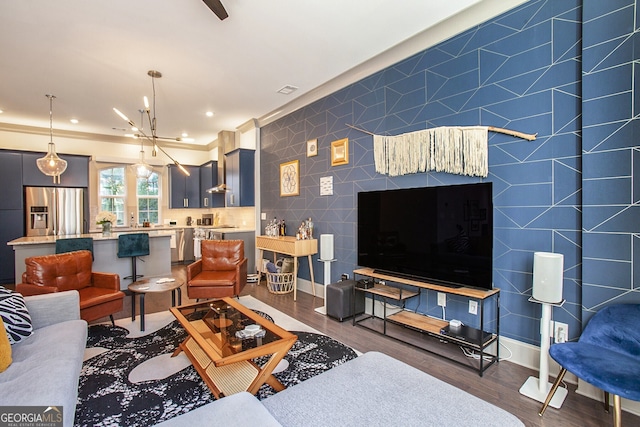 living room with recessed lighting, tile walls, baseboards, and wood finished floors