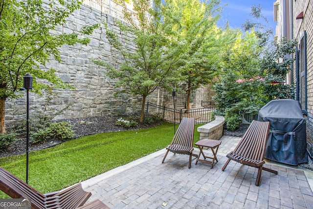 view of patio / terrace featuring fence and grilling area