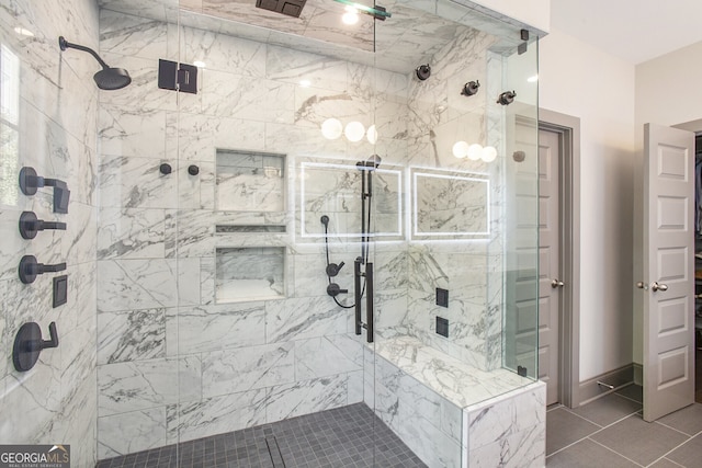 full bath featuring a stall shower and baseboards