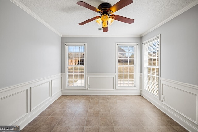 1409 Nantucket Dr, Bethlehem, GA 30620 - spare room with a ceiling fan, a textured ceiling, crown molding, a decorative wall, and light tile patterned floors