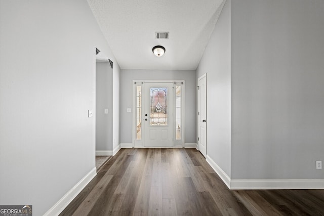 1409 Nantucket Dr, Bethlehem, GA 30620 - foyer entrance featuring dark wood finished floors and a textured ceiling