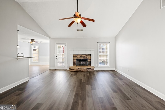 1409 Nantucket Dr, Bethlehem, GA 30620 - unfurnished living room with a ceiling fan, healthy amount of natural light, a fireplace, and high vaulted ceiling