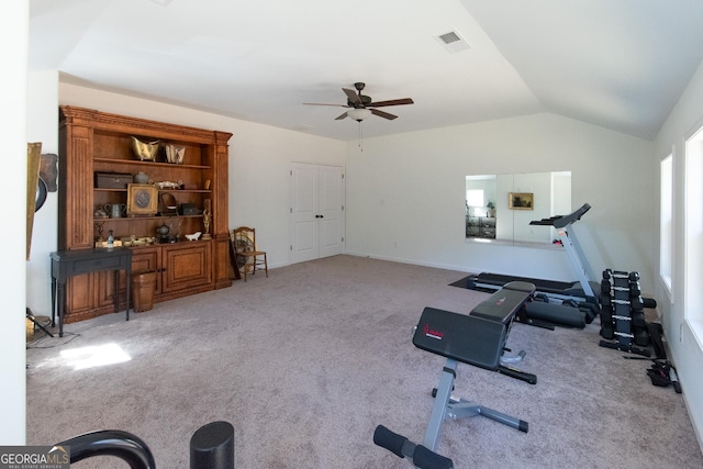 workout area with ceiling fan, visible vents, vaulted ceiling, and carpet flooring