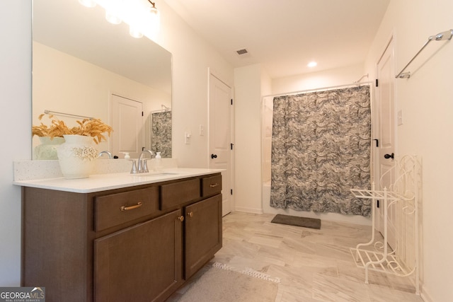 full bath featuring visible vents, vanity, and shower / bath combo with shower curtain