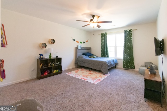 bedroom with a ceiling fan, carpet flooring, and baseboards