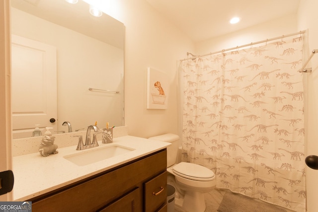 full bathroom with curtained shower, vanity, and toilet