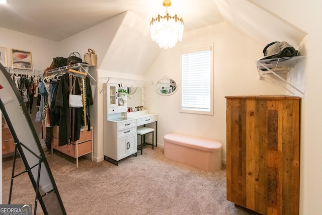 bathroom with lofted ceiling and a notable chandelier