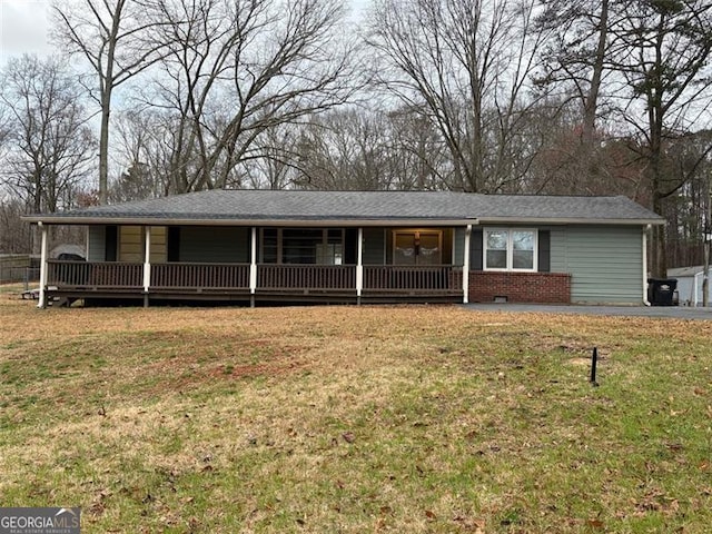 single story home with covered porch, crawl space, brick siding, and a front lawn