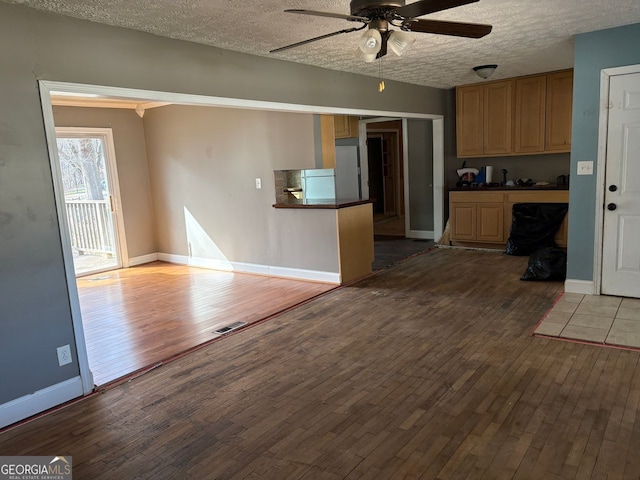 kitchen featuring dark countertops, wood finished floors, and visible vents