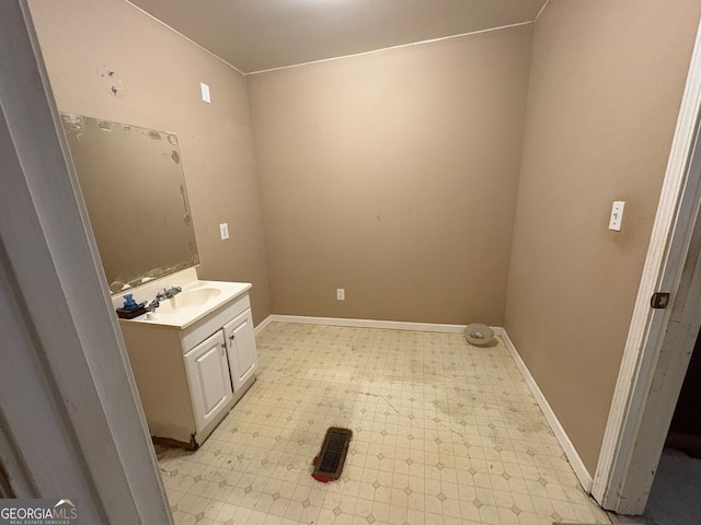 bathroom featuring baseboards, vanity, and tile patterned floors