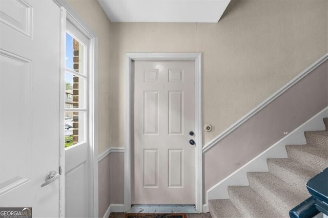 interior space with stairway and baseboards