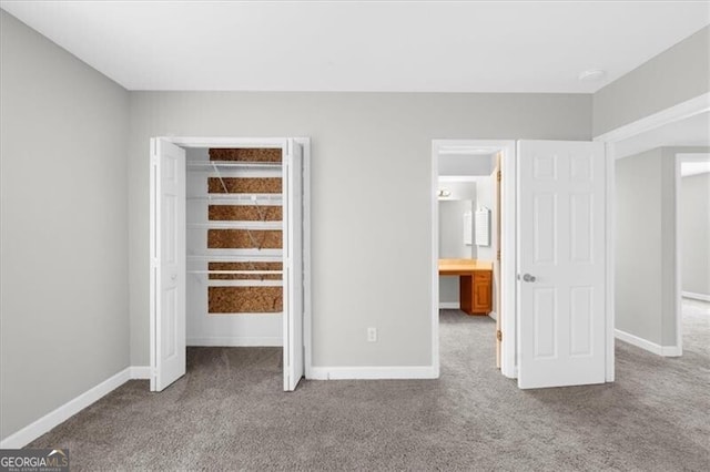 unfurnished bedroom featuring carpet flooring and baseboards