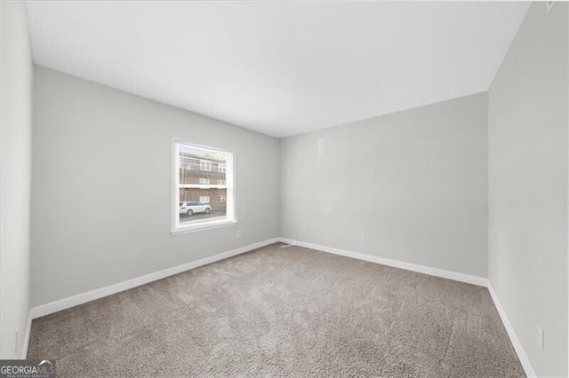 empty room with carpet and baseboards